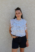 Blouse sans manches avec pois noirs effet ruché dos nu